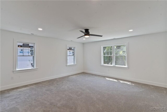 carpeted spare room with ceiling fan