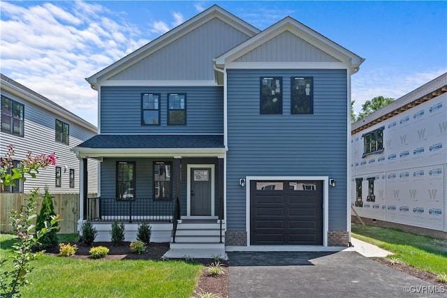 view of front facade with a garage and a porch