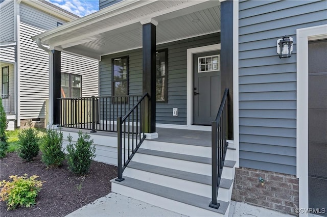 view of exterior entry with a porch