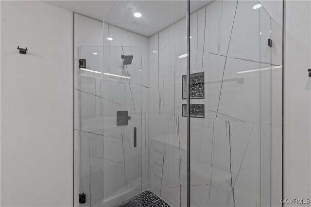 bathroom featuring a shower with door