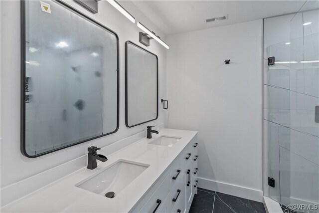 bathroom with an enclosed shower, vanity, and tile patterned flooring