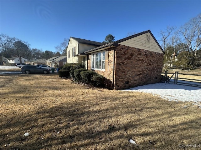 view of side of property with a yard