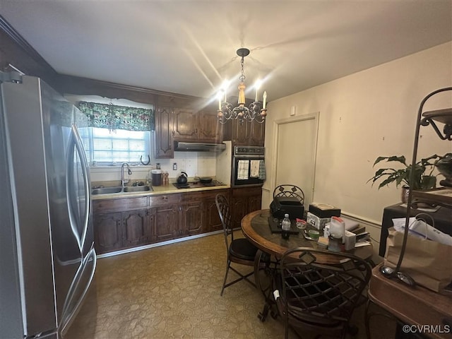 kitchen featuring pendant lighting, black appliances, sink, an inviting chandelier, and dark brown cabinets