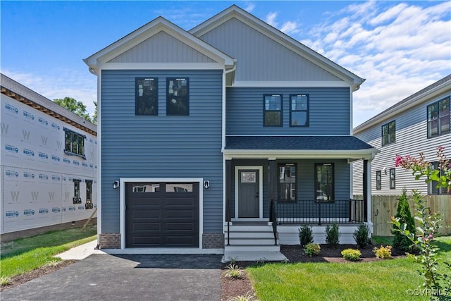 view of front of property featuring covered porch and a garage