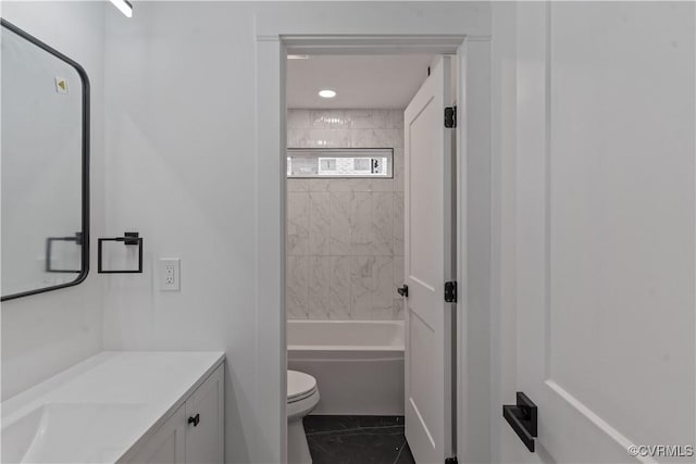 full bathroom featuring toilet, vanity, and tiled shower / bath combo