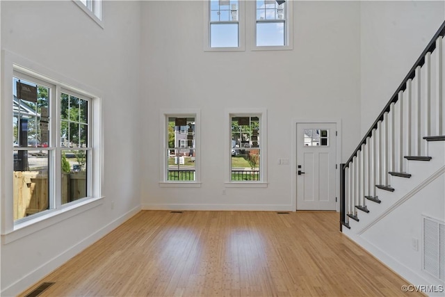 foyer featuring a high ceiling and light hardwood / wood-style flooring