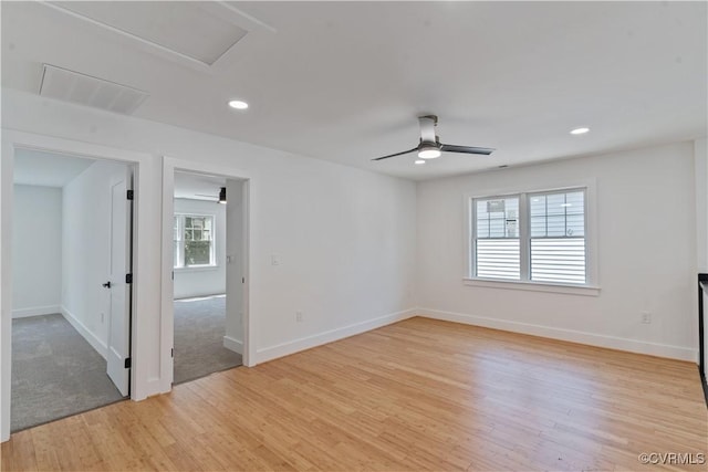 unfurnished room featuring ceiling fan, a healthy amount of sunlight, and light wood-type flooring