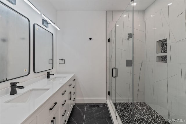 bathroom featuring walk in shower and vanity