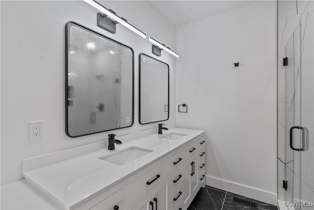 bathroom with a shower with door and vanity