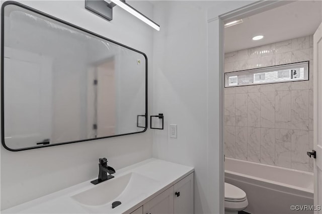 full bathroom featuring toilet, vanity, and tiled shower / bath