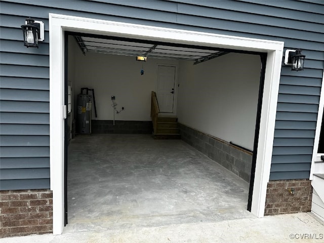 garage with electric water heater and a garage door opener