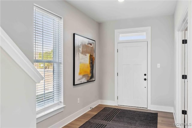 entryway with baseboards and wood finished floors