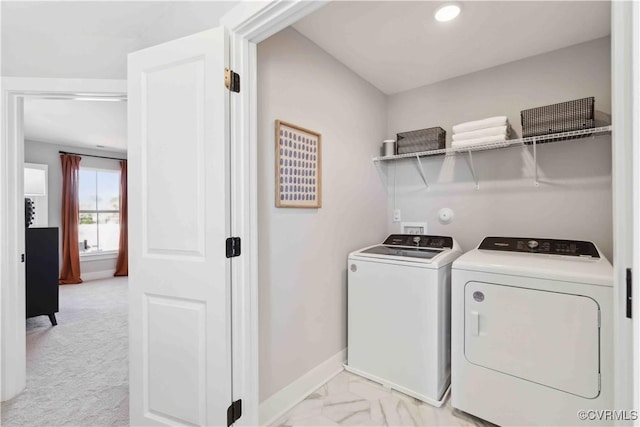 laundry room featuring laundry area, washing machine and dryer, baseboards, and marble finish floor