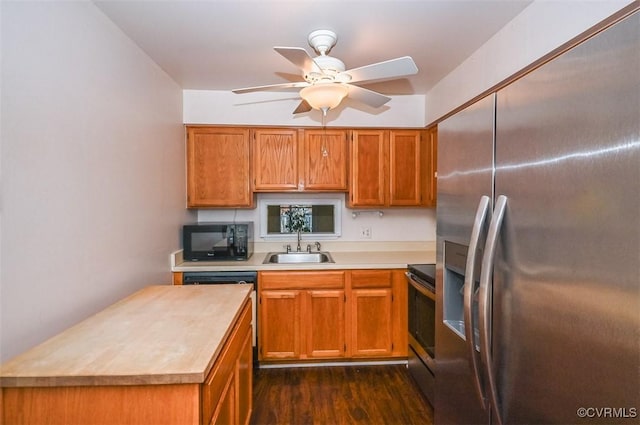 kitchen with dark wood-type flooring, sink, appliances with stainless steel finishes, and ceiling fan