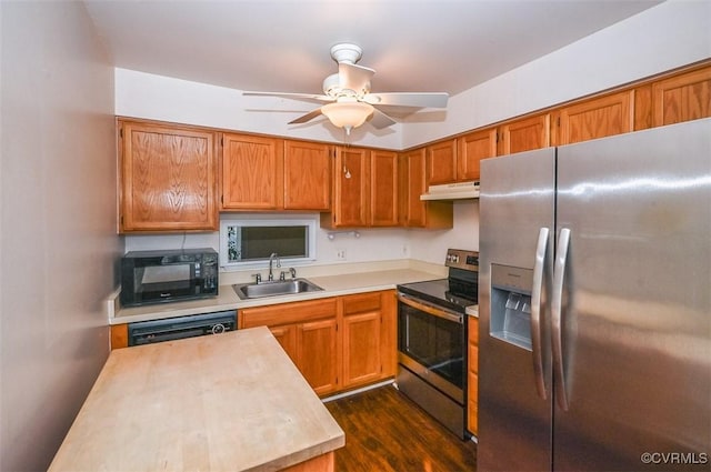 kitchen featuring dark wood-type flooring, ceiling fan, sink, and black appliances