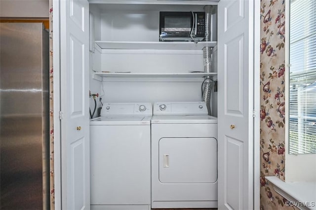 clothes washing area featuring independent washer and dryer and a healthy amount of sunlight