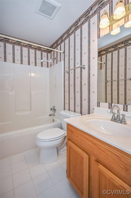 full bathroom with toilet, vanity, tile patterned floors, and shower / washtub combination