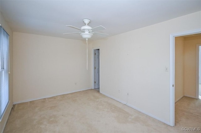 carpeted spare room with ceiling fan