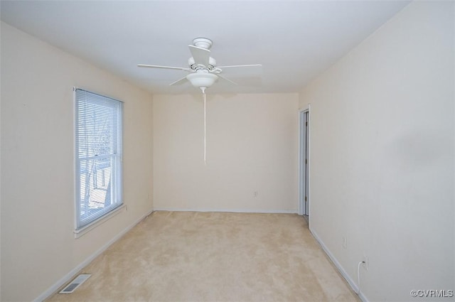 unfurnished room featuring light carpet and ceiling fan