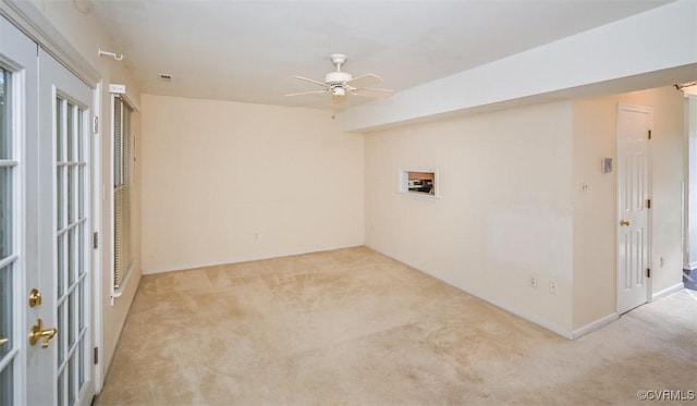 unfurnished room featuring ceiling fan and light colored carpet