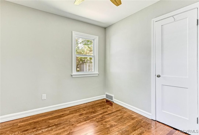 empty room featuring ceiling fan and hardwood / wood-style floors