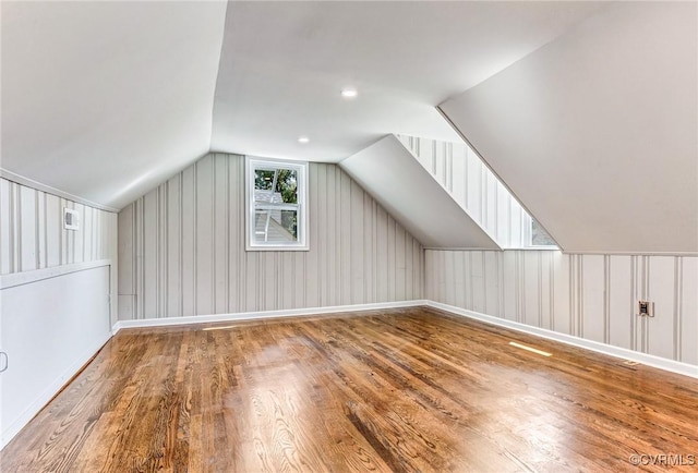 bonus room featuring lofted ceiling and hardwood / wood-style flooring