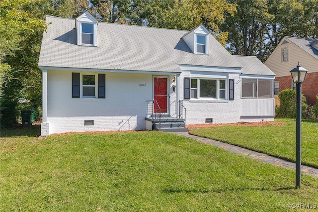 cape cod-style house with a front yard