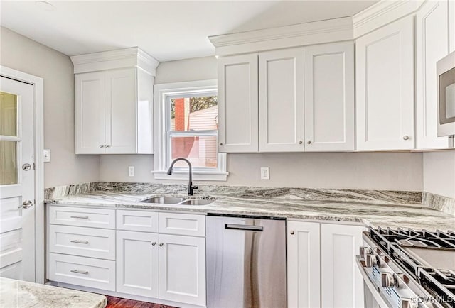 kitchen featuring white cabinets, light stone countertops, sink, and stainless steel appliances