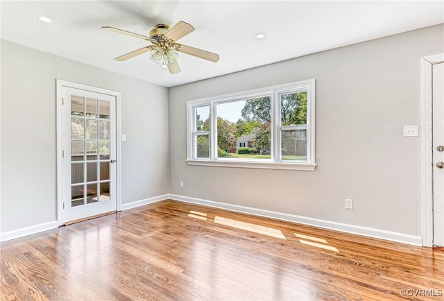 unfurnished room with ceiling fan and wood-type flooring