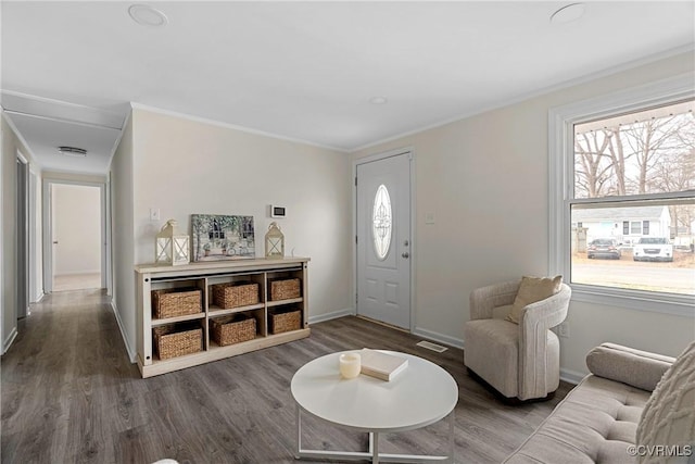 foyer featuring crown molding and hardwood / wood-style flooring