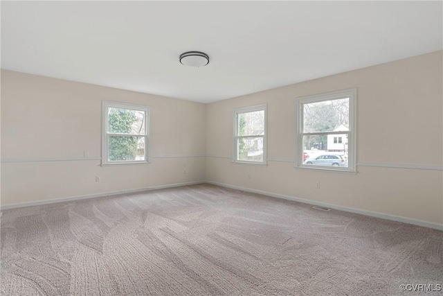 unfurnished room with light colored carpet