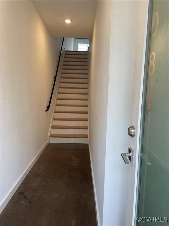 stairway with concrete floors