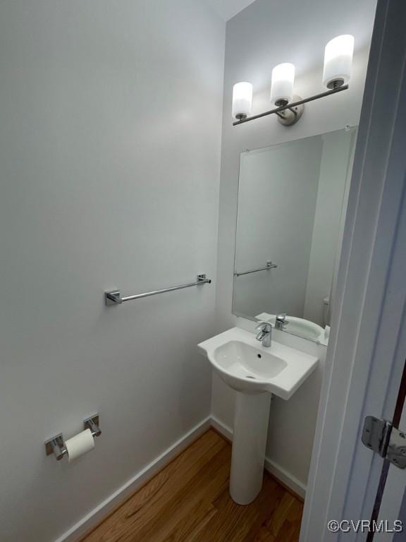 bathroom featuring wood-type flooring and sink