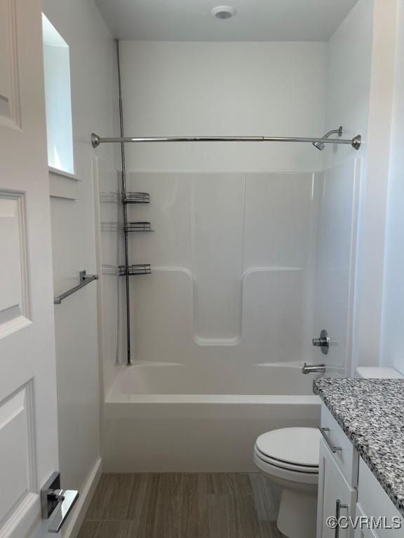 full bathroom with toilet, vanity, tub / shower combination, and hardwood / wood-style floors