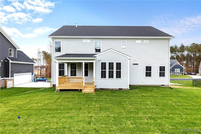 rear view of house with a garage, a yard, and a porch