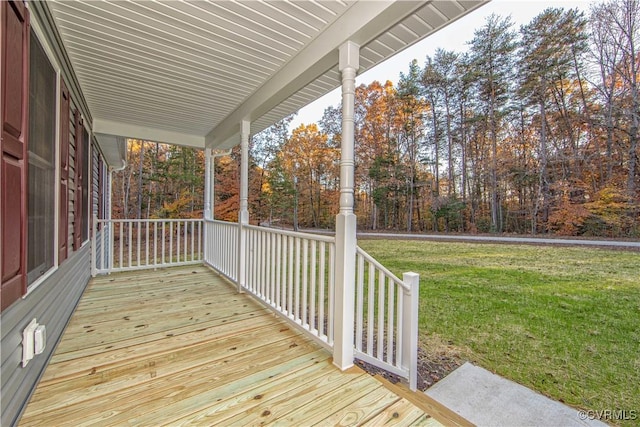 deck with covered porch and a lawn