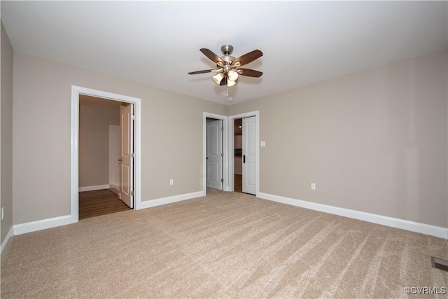 unfurnished bedroom with ceiling fan, carpet, and connected bathroom