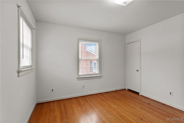 unfurnished room with a wealth of natural light and light hardwood / wood-style floors