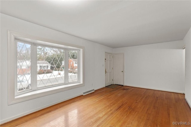 spare room featuring light wood-type flooring