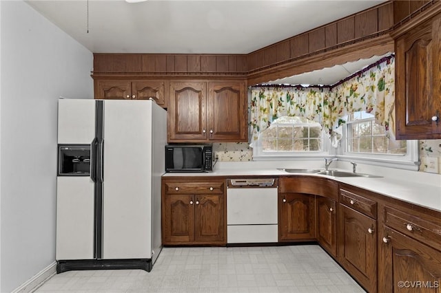 kitchen featuring sink and white appliances