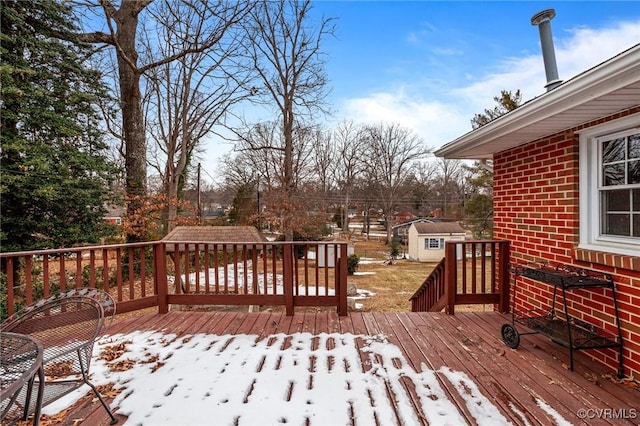 snow covered deck with a storage unit