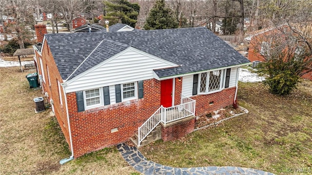 view of front of property with central AC and a front lawn