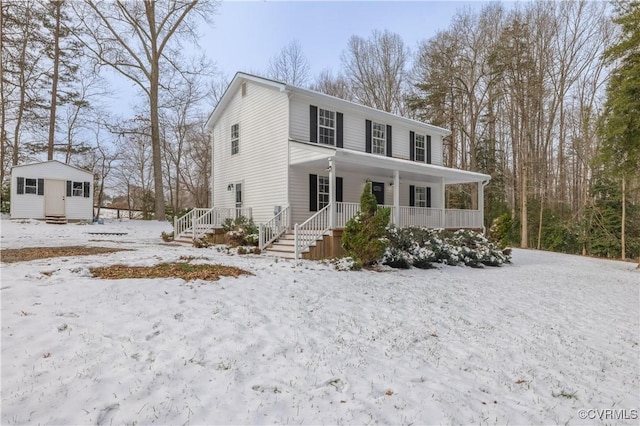 view of front of property with covered porch and an outbuilding