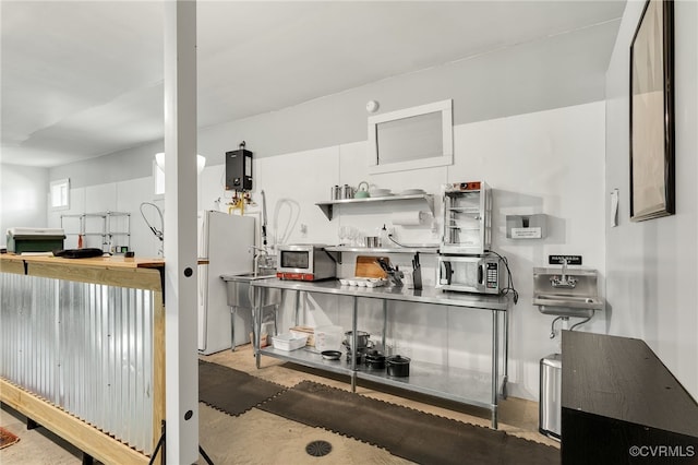 kitchen featuring white cabinetry and white refrigerator