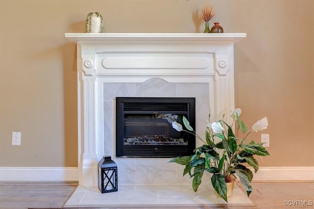 interior details featuring a tile fireplace