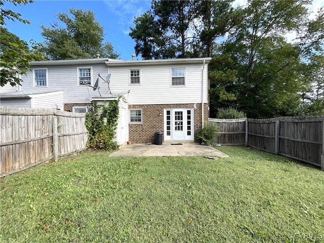 back of property featuring a patio area and a lawn