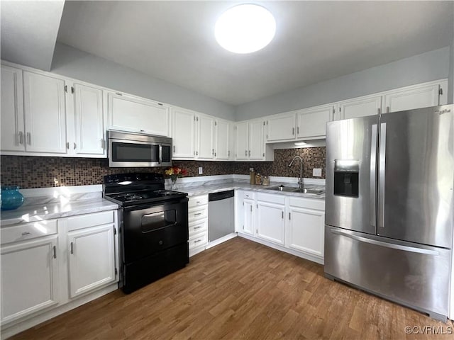 kitchen featuring sink, stainless steel appliances, and white cabinetry