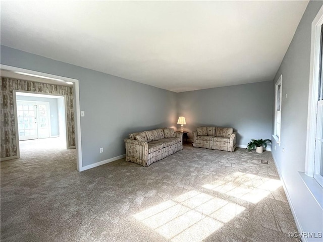 unfurnished living room featuring light carpet