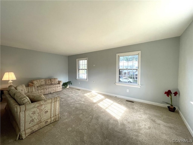 unfurnished living room with carpet and a healthy amount of sunlight