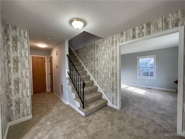 staircase featuring carpet floors